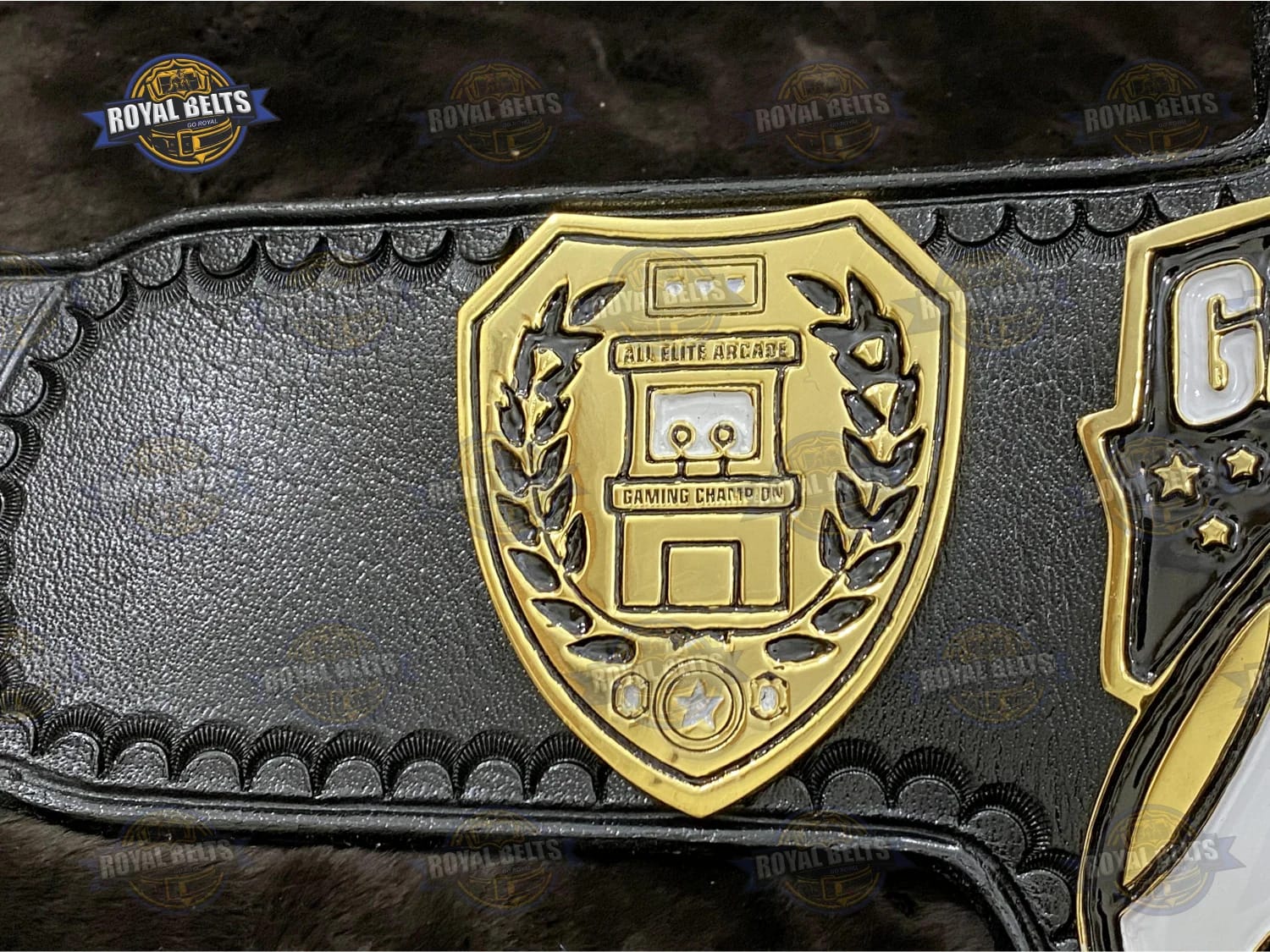 All Elite Arcade title belt showing bold logo engraving and curved heavyweight plates