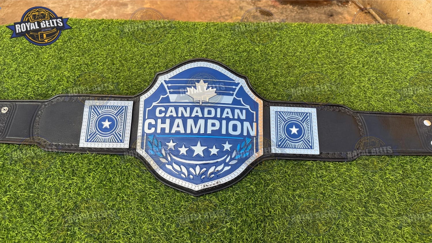 Custom Canadian championship belt with raised maple emblem center plate, mirror polished metal, cowhide leather