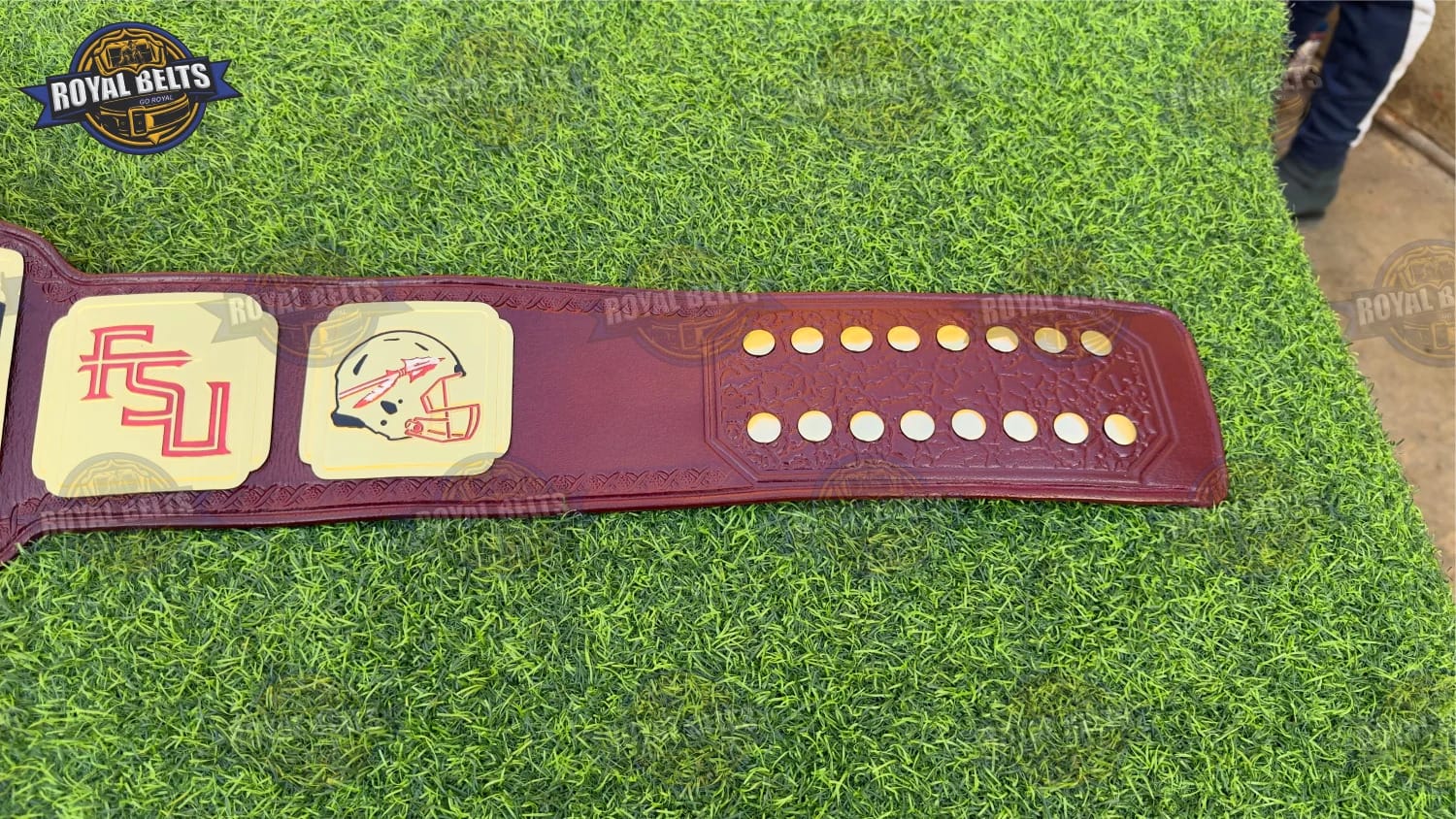 FSU national title belt showing raised lettering and curved heavyweight metal plates