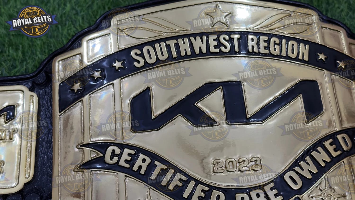 KIA Southwest Region belt collectible with polished gold metal and leather backing