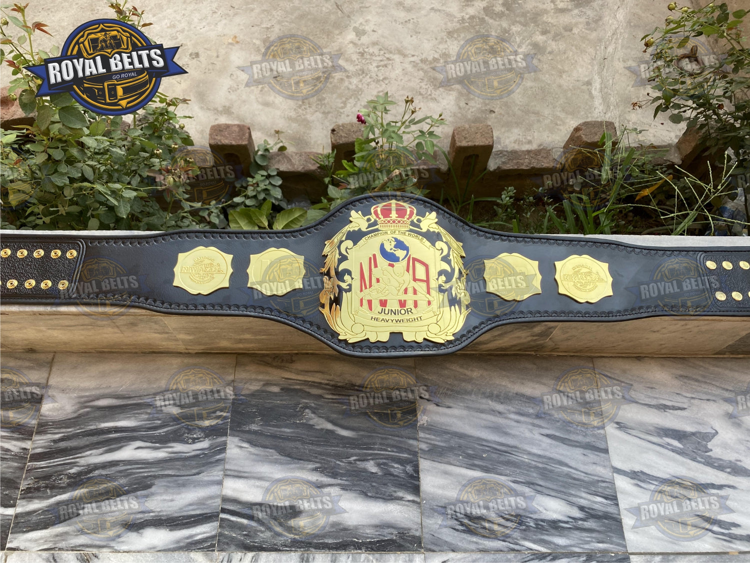 NWA Junior Title Belt embossed text, smooth metal surface, reinforced leather strap, beveled plates