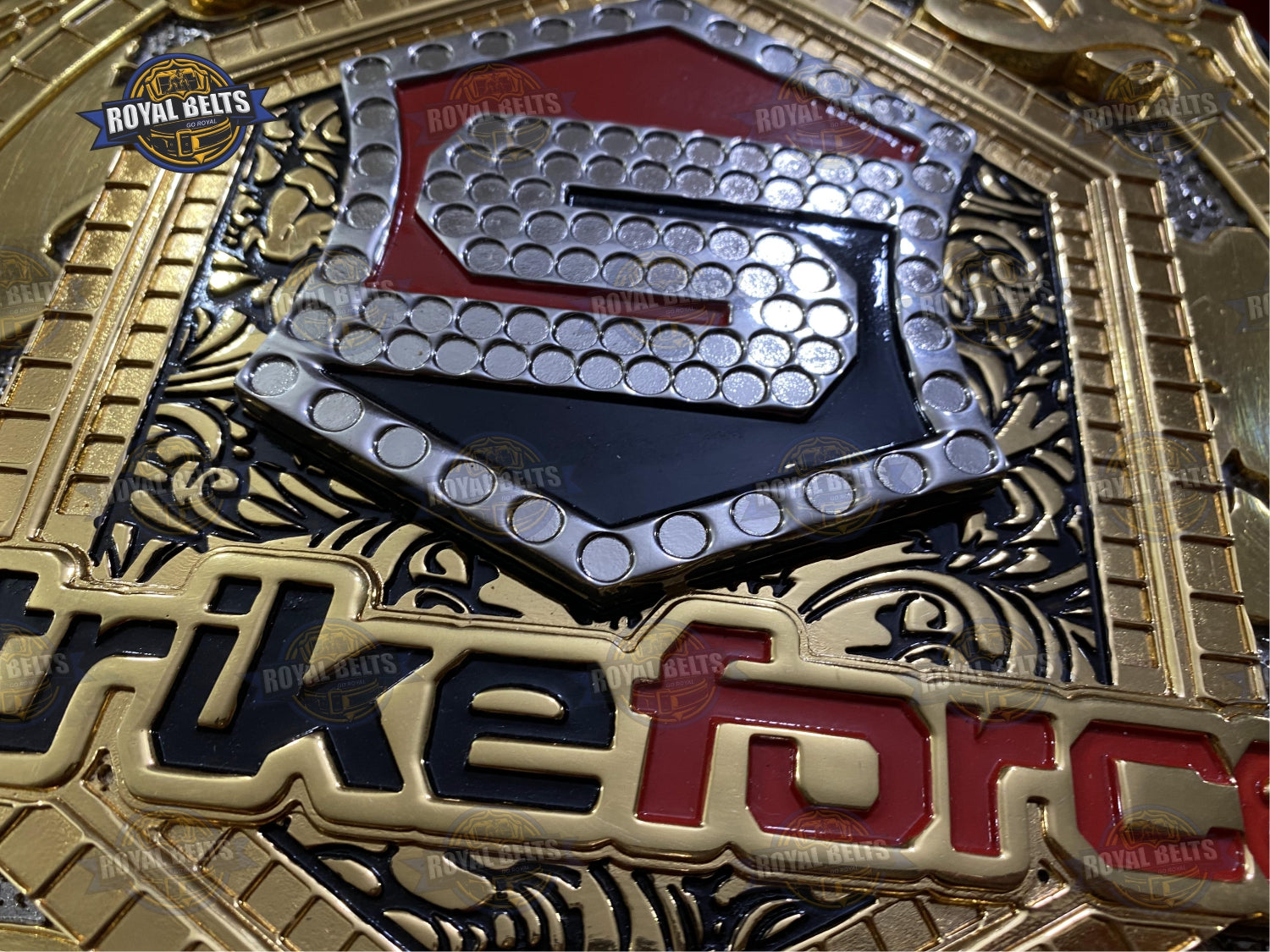 Strikeforce title belt with beveled triple stacked plates, polished gold layers, reinforced leather strap