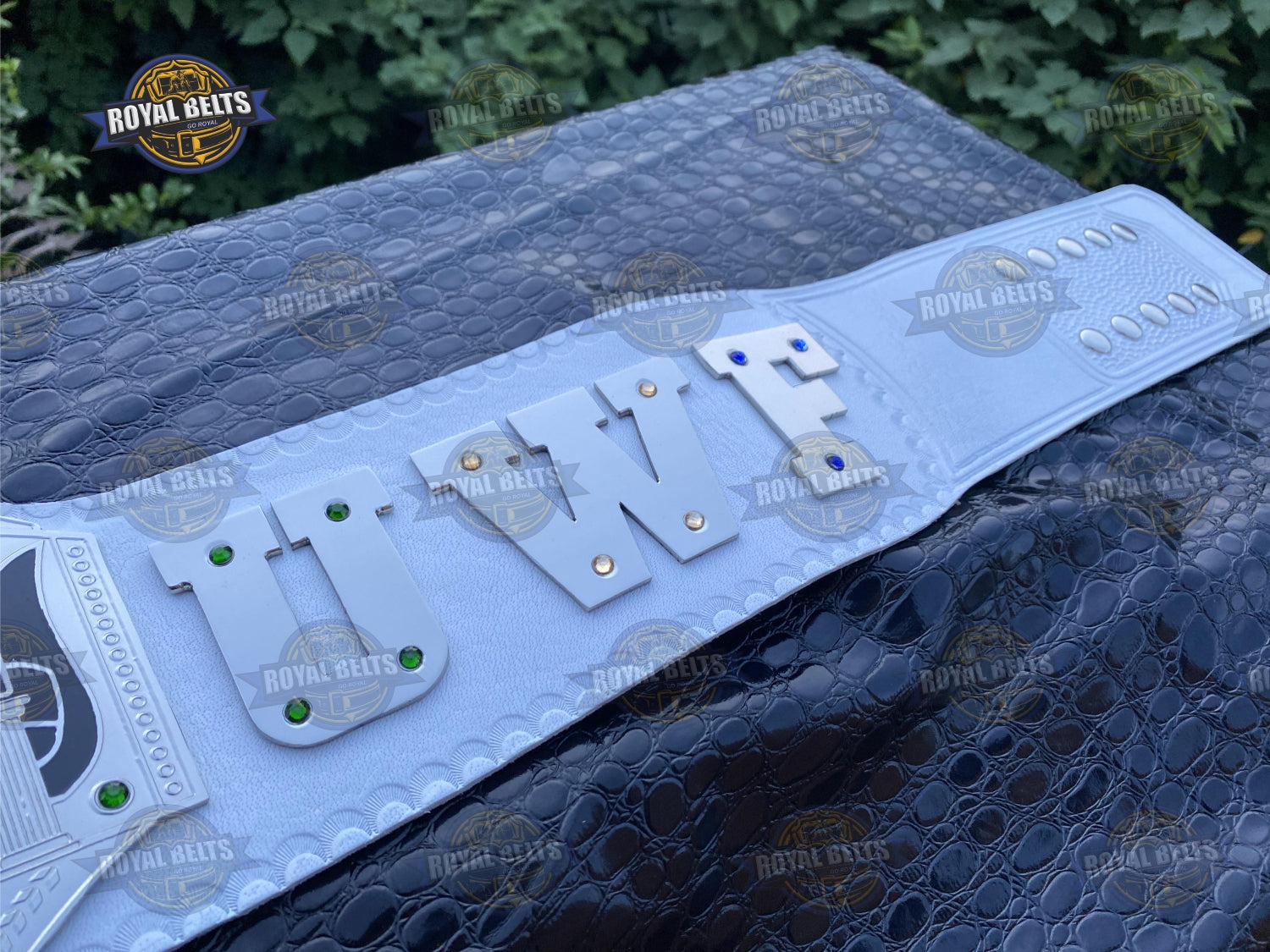 UWF Heavyweight belt with thick embossed plates, premium brass metal, stitched black leather backing