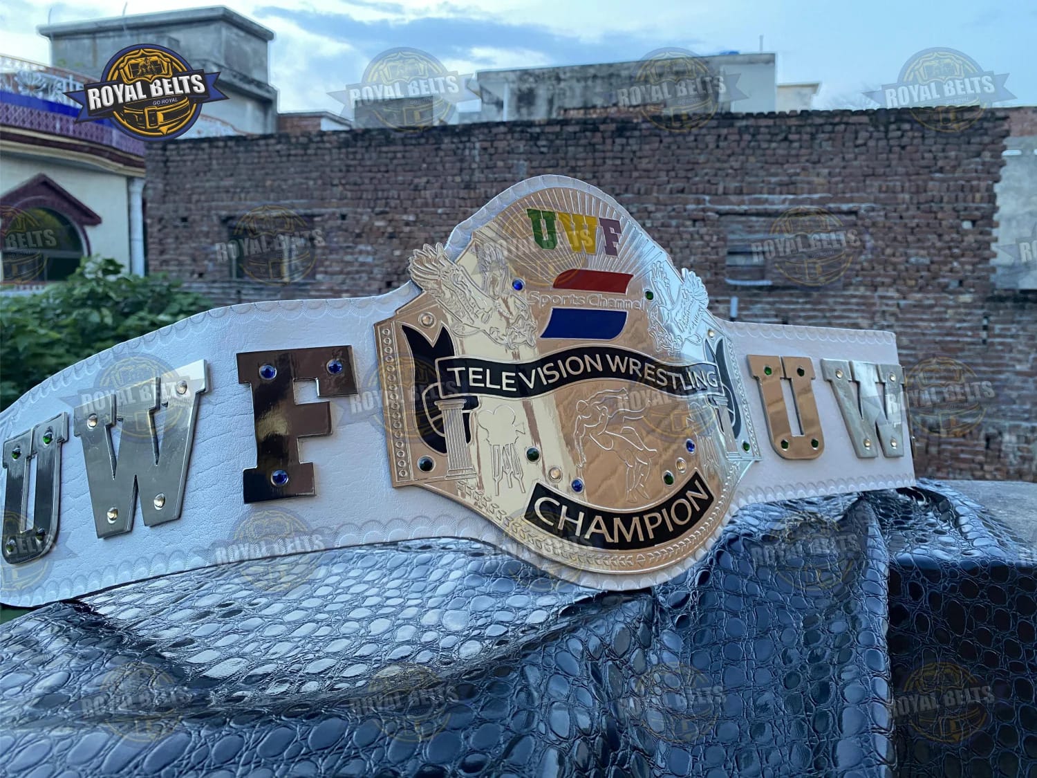 Custom UWF Heavyweight title belt with raised emblem, mirror polished gold , adjustable black leather Crafted by Royal Belts 