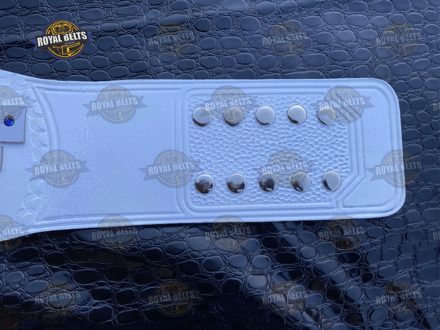 UWF Heavyweight belt featuring mirror-finish chrome plates, snap fit black leather strap, raised emblem