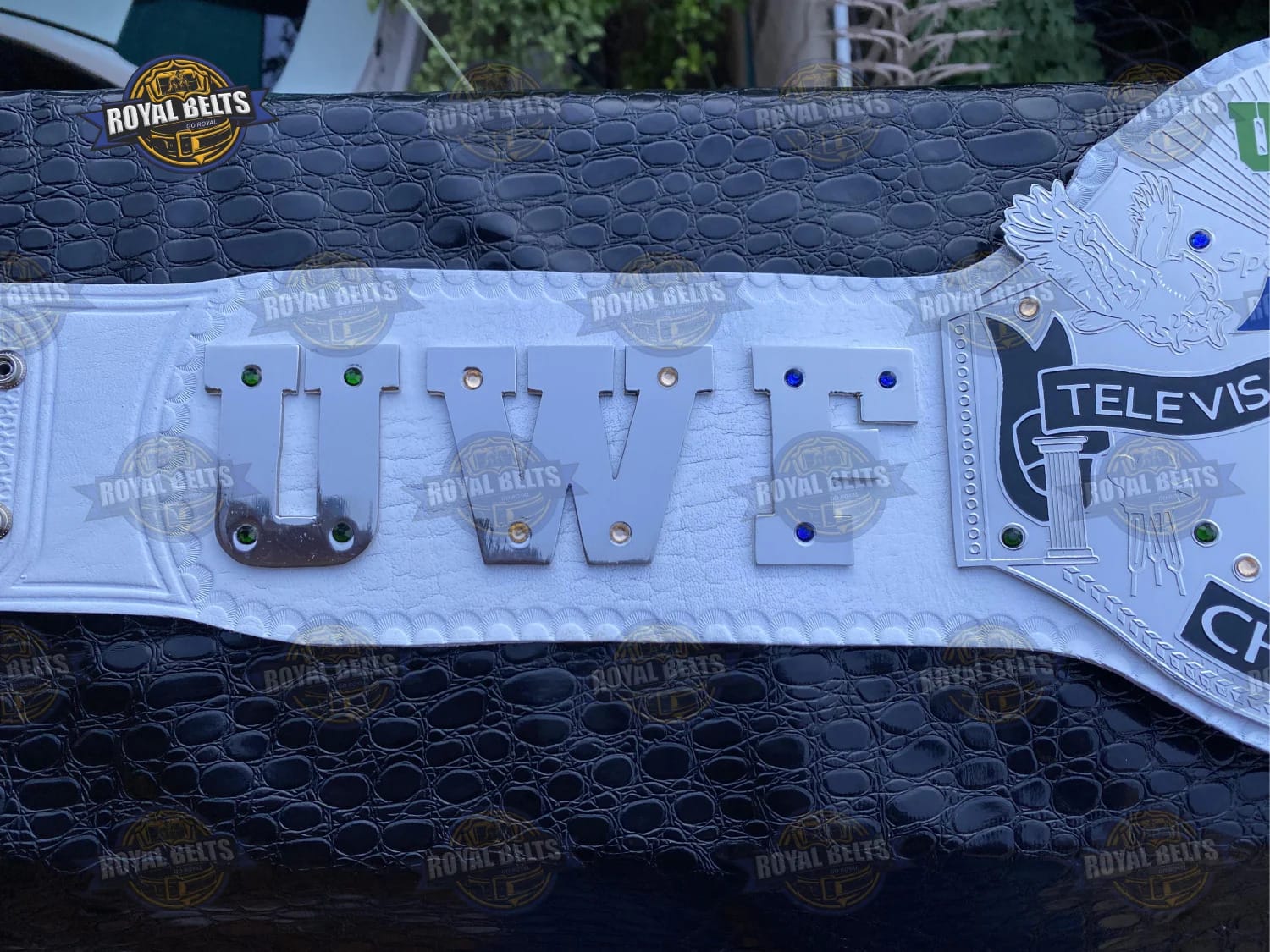 Custom UWF title belt with precision-etched center plate, luxury metal, stitched leather backing