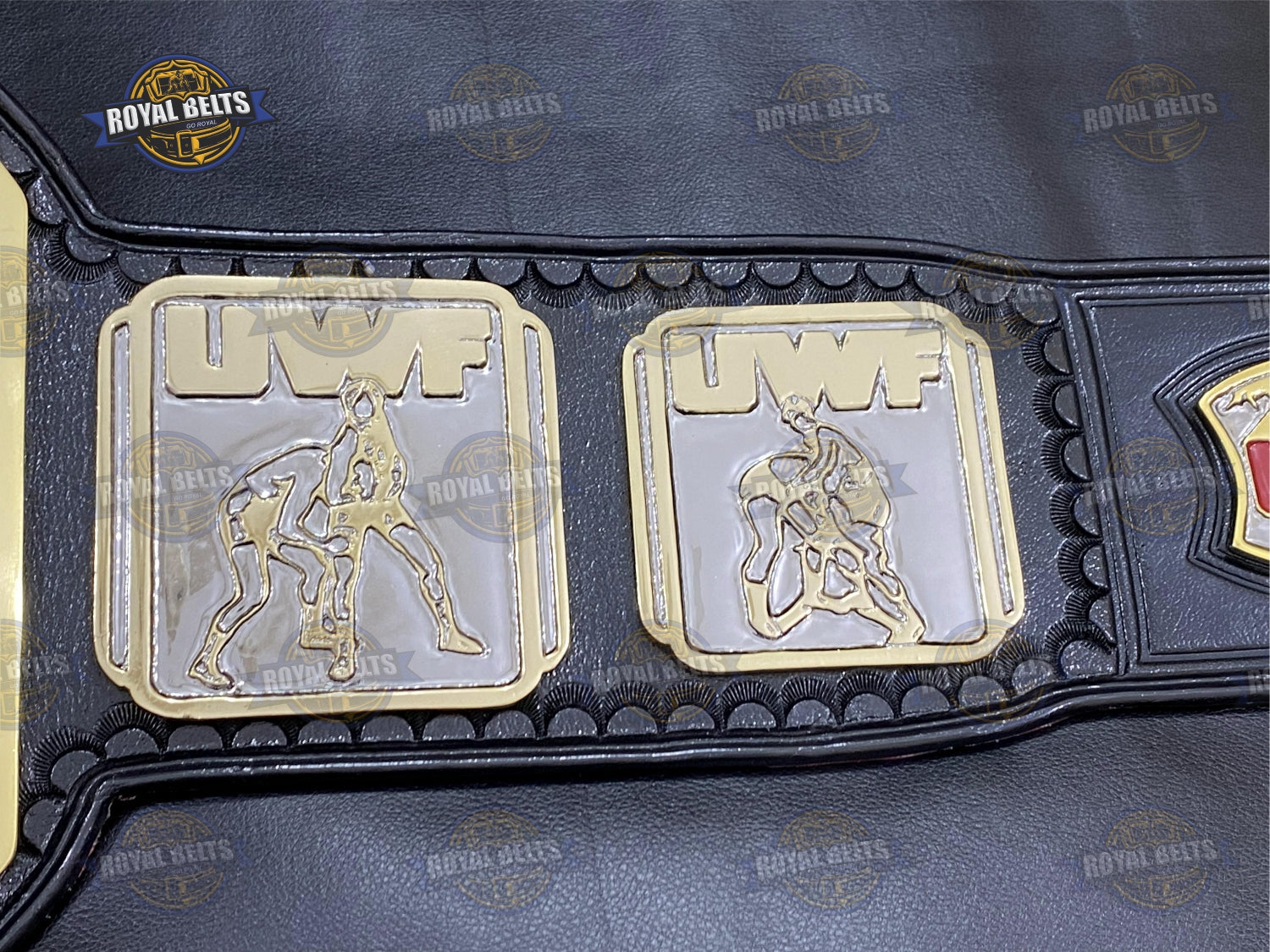 UWF belt with engraved side plates, HD CNC detailing, durable stitched black leather backing