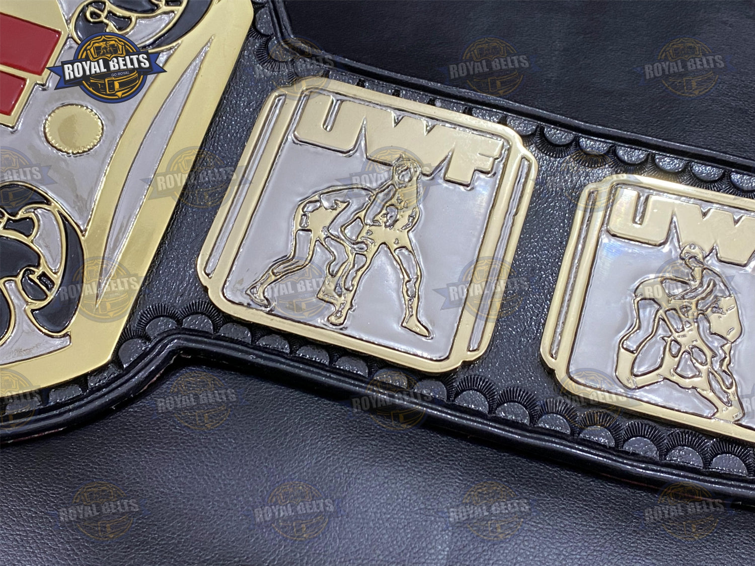 UWF belt with bold embossed center plate, thick zinc metal, black leather strap with reinforced stitching