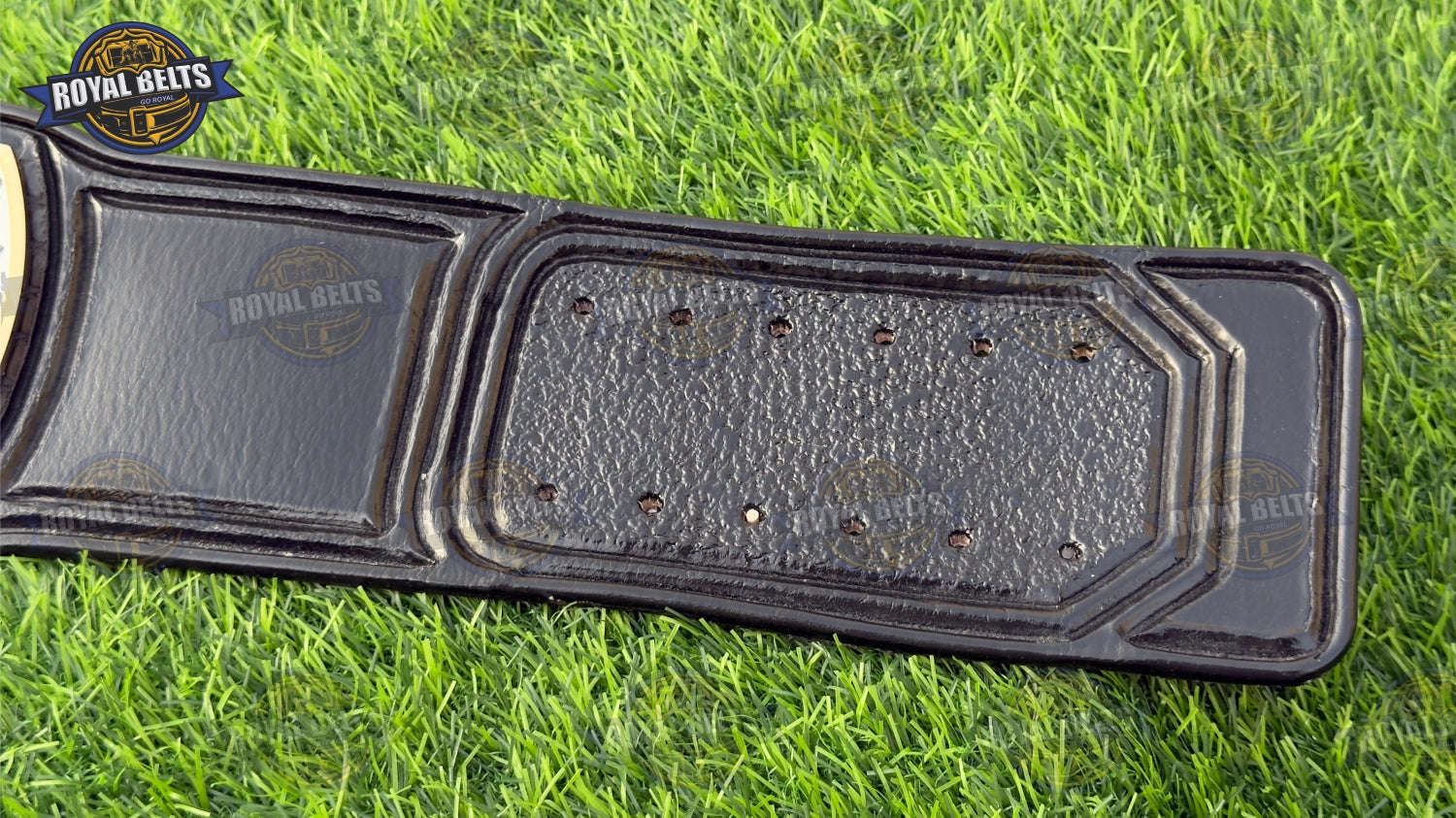 Custom UWF HD CNC championship belt featuring detailed side plates, polished gold finish, adjustable leather