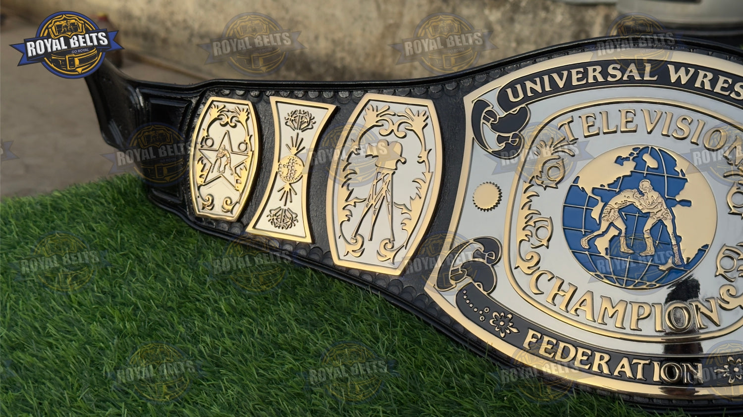 UWF Universal TV belt displaying bold raised center emblem, thick dual plated plates, stitched black cowhide leather