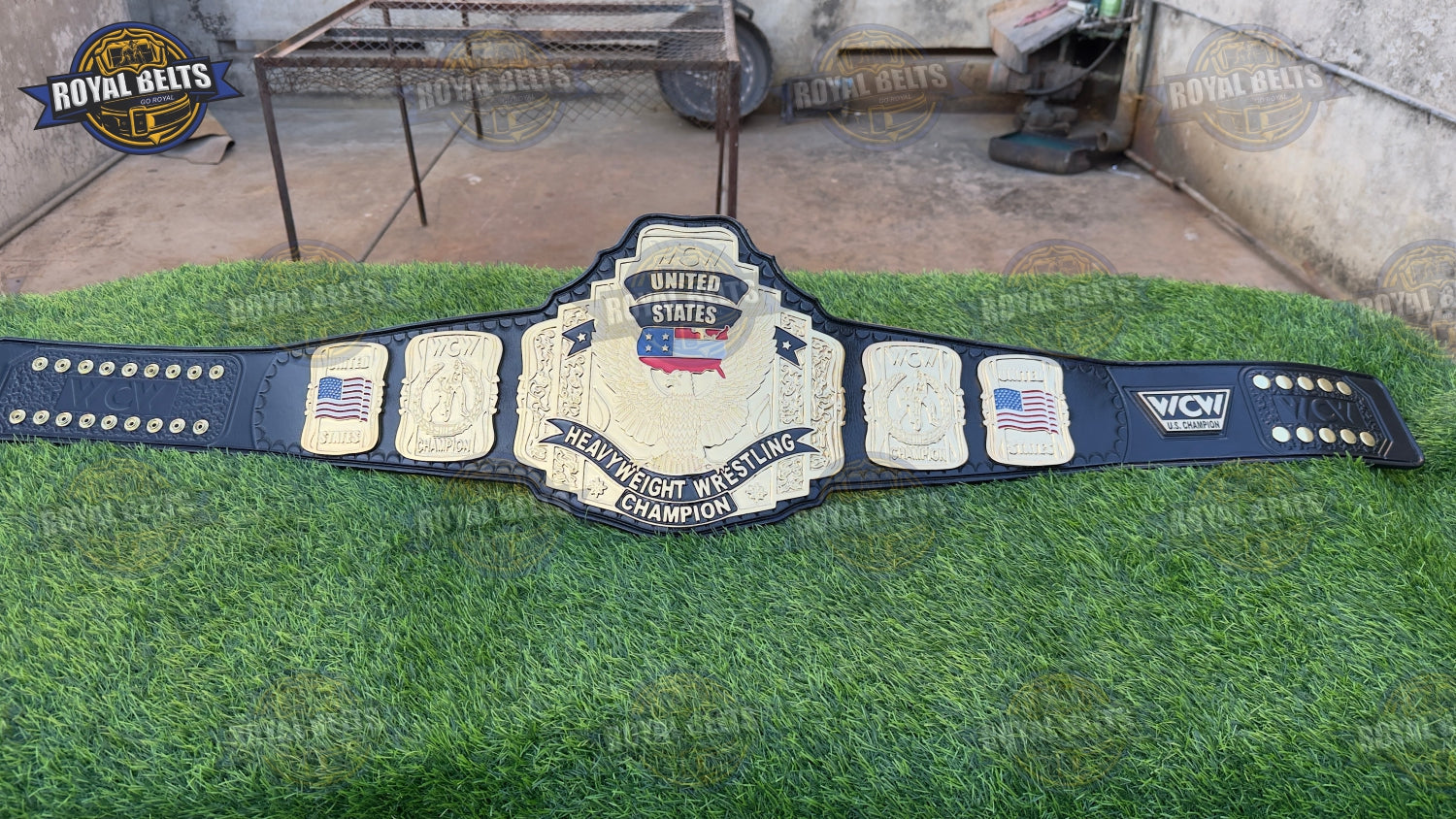 US championship belt with ornate side plates, detailed CNC etching, high gloss gold finish, stitched leather strap