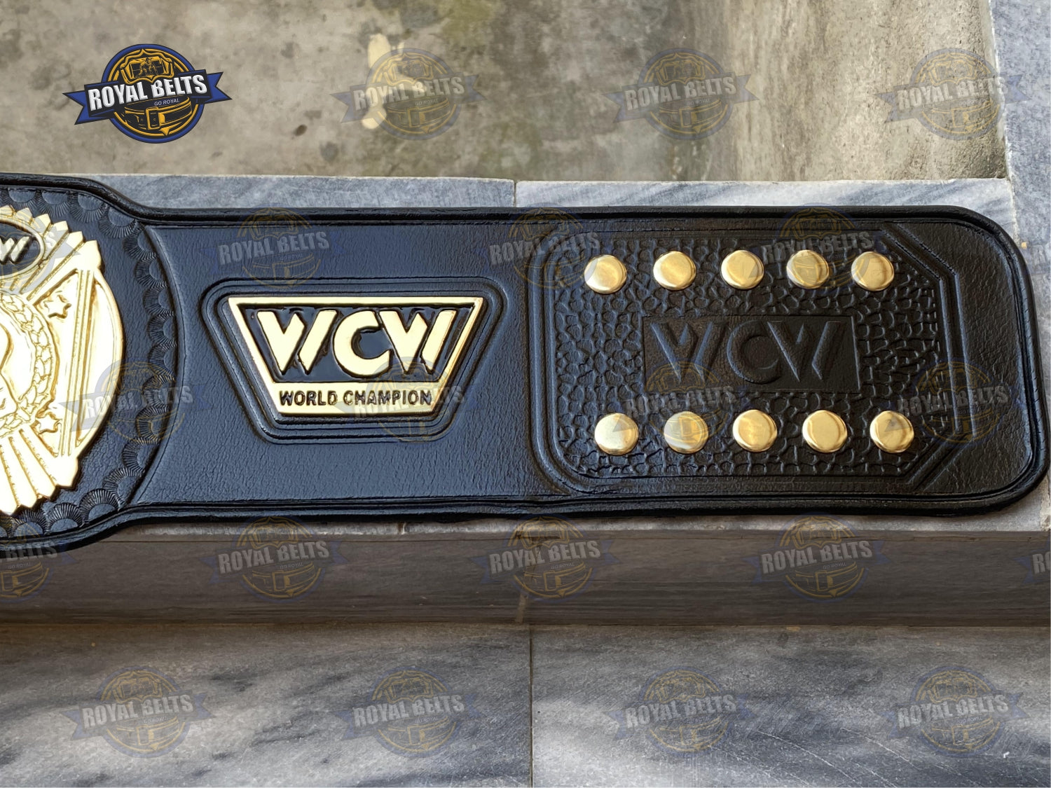 Championship belt with beveled gold plates, mirror polished finish, reinforced stitched leather strap