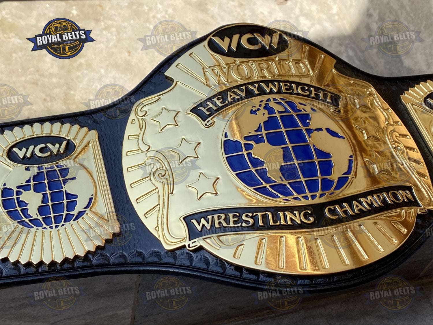 WCW World Wrestling championship belt featuring ornate side plates, polished gold finish, adjustable leather strap