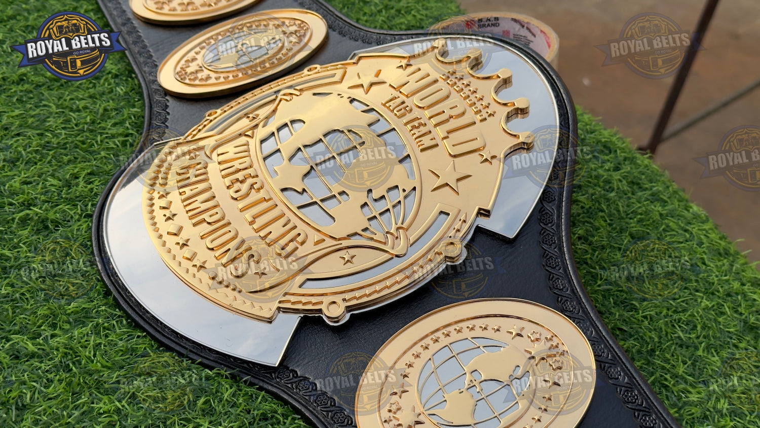Custom World Tag Team championship belt with ornate CNC side plates, deep engraving, genuine leather strap