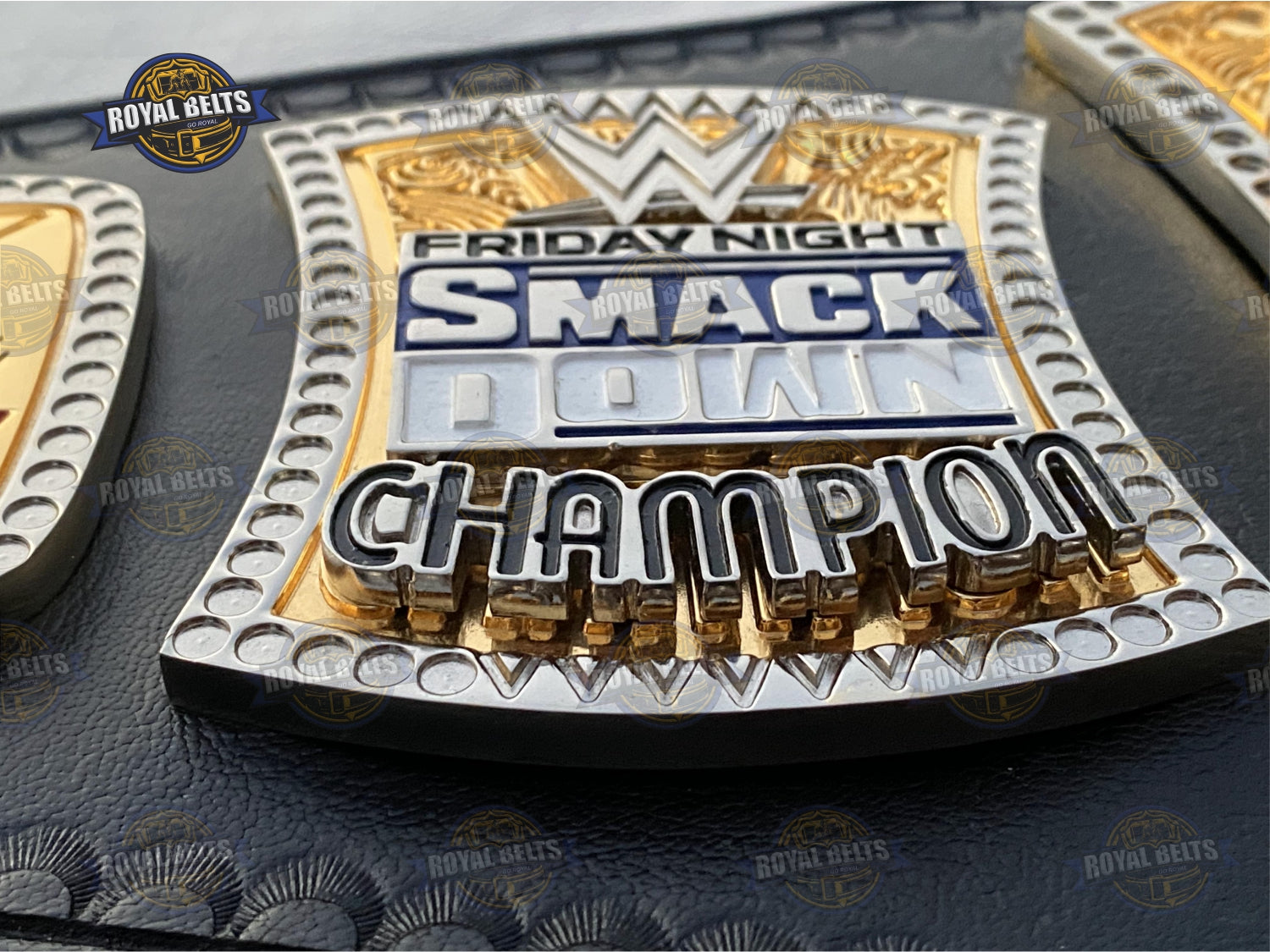 WWE belt with raised spinning center emblem, layered dual plates, premium stitched leather strap