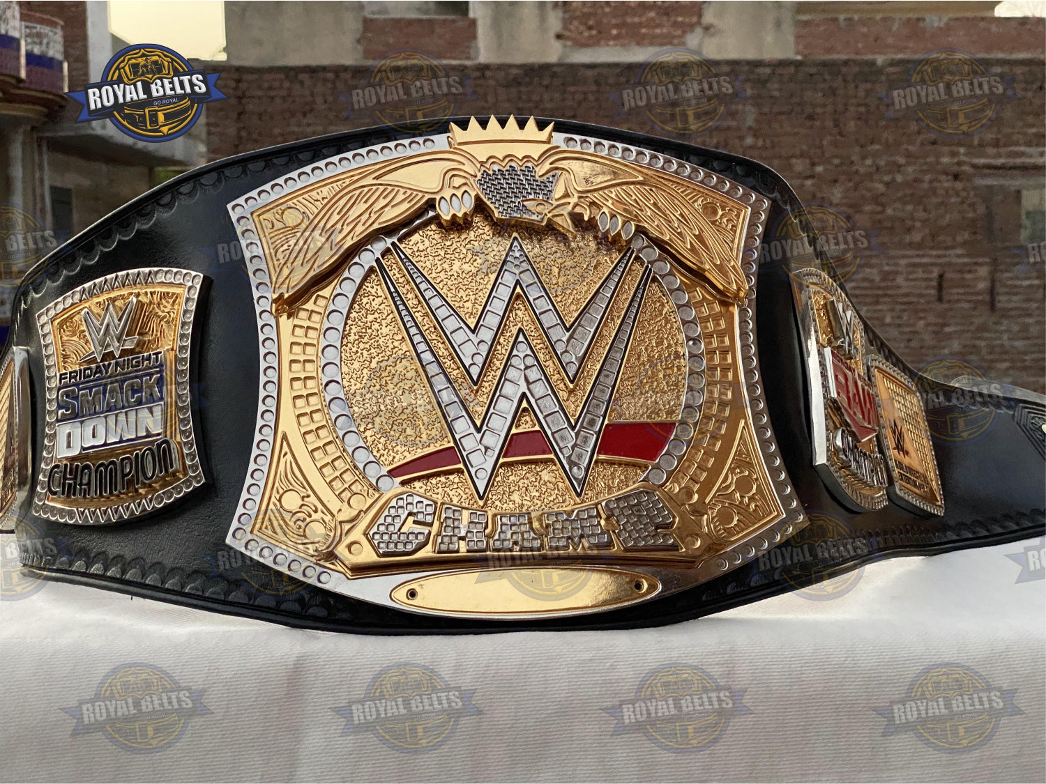 WWE championship belt with ornate side plates, CNC engraved designs, durable black leather backing