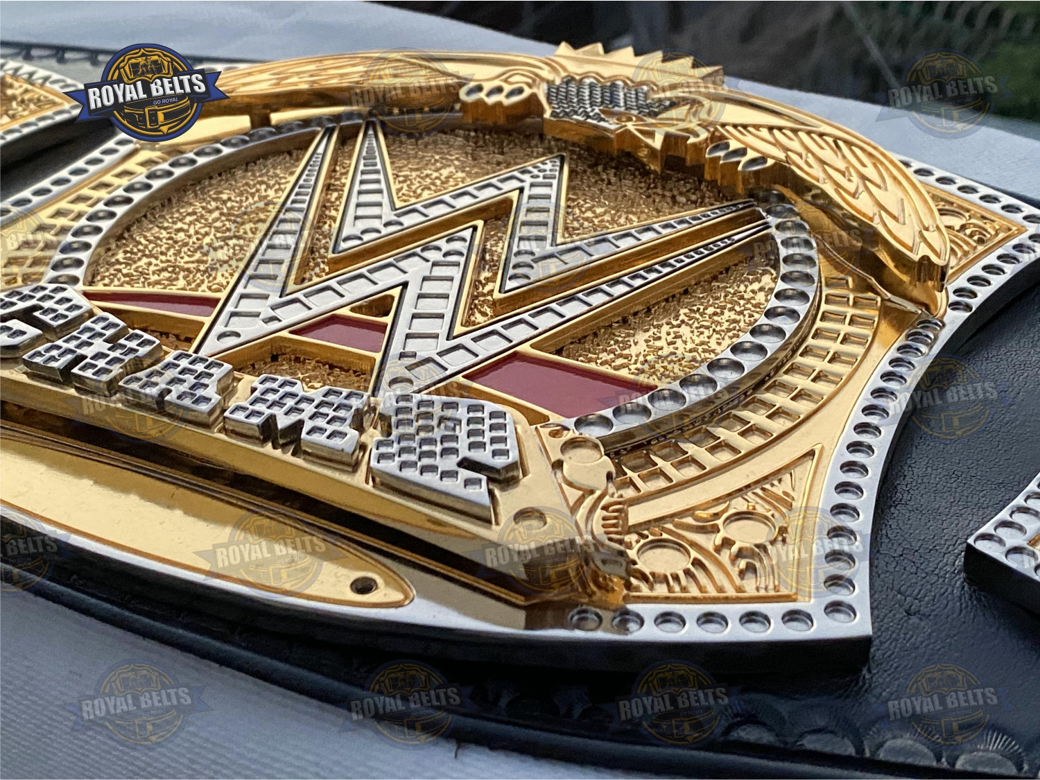 Spinner belt with embossed gold center, high gloss finish, premium stitched leather strap