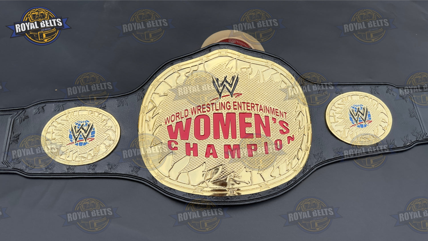 Custom WWE Women’s belt with raised center logo, mirror polished gold metal, adjustable leather strap Crafted by Royal Belts