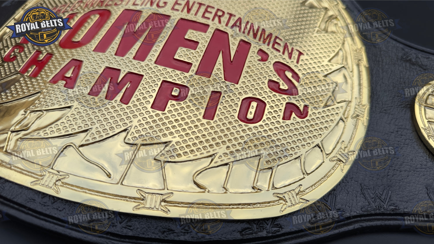 Custom WWE Women’s title belt with ornate side plates, deep engraving, premium genuine leather strap