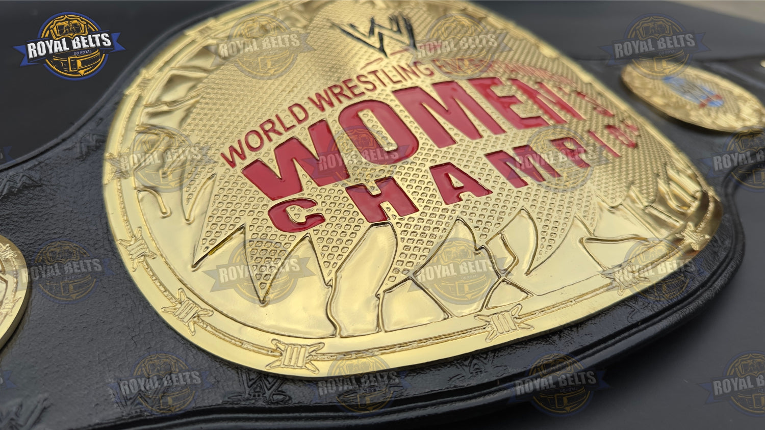 Women’s wrestling title belt with mirror finish gold plates, reinforced leather backing, raised emblem