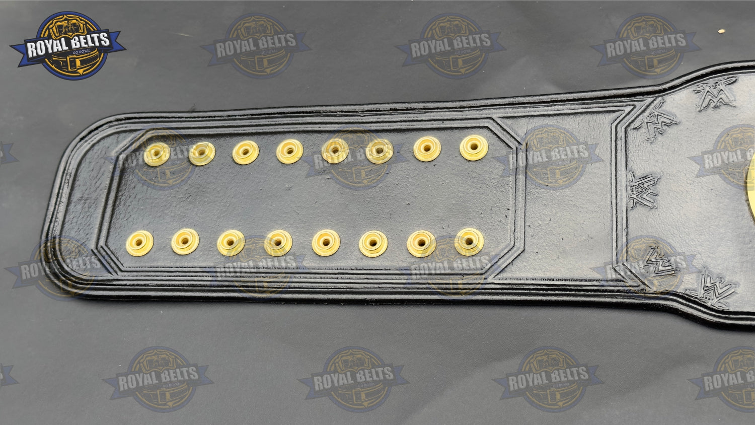 Custom WWE Women’s belt with deep-etched center plate, premium gold metal, stitched leather strap